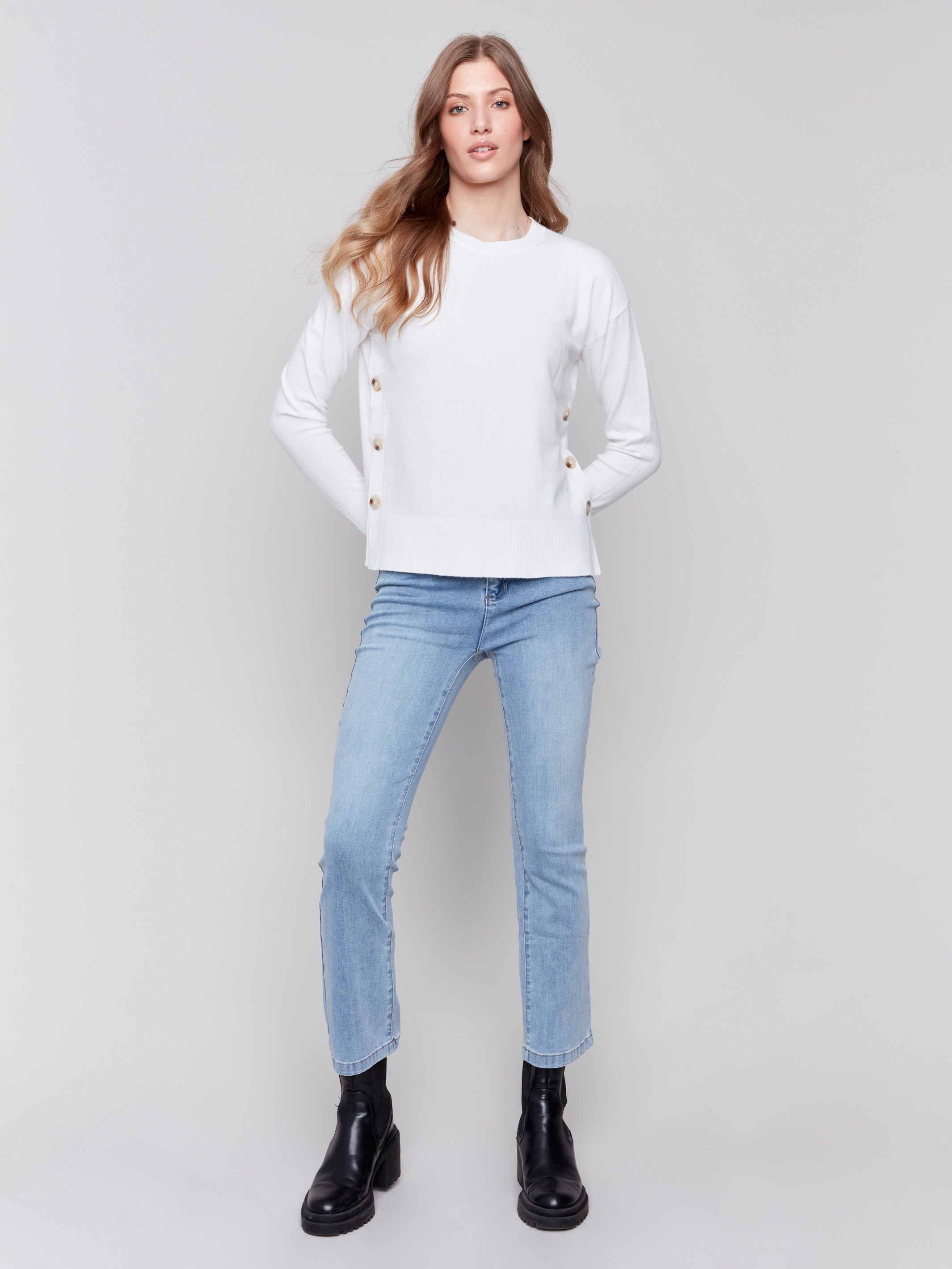 Cream white sweater with long sleeves and side button detailing by Charlie B.