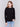 Black sweater with long sleeves and side button detailing by Charlie B.