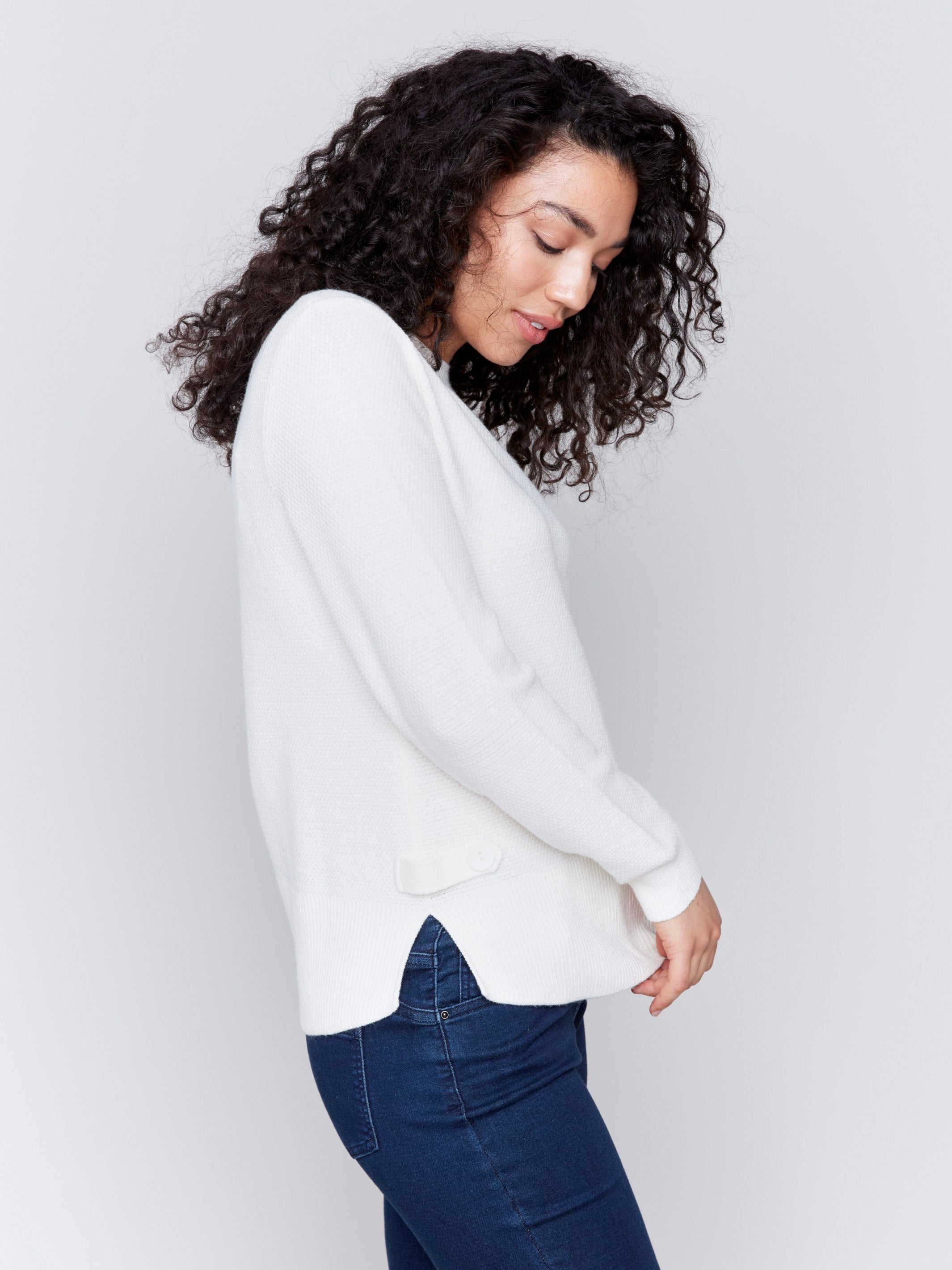 Ecru white sweater with long sleeves featuring side tab details and a round hem by Charlie B.