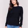 Black sweater with long sleeves featuring side tab details and a round hem by Charlie B.