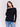 Black sweater with long sleeves featuring side tab details and a round hem by Charlie B.