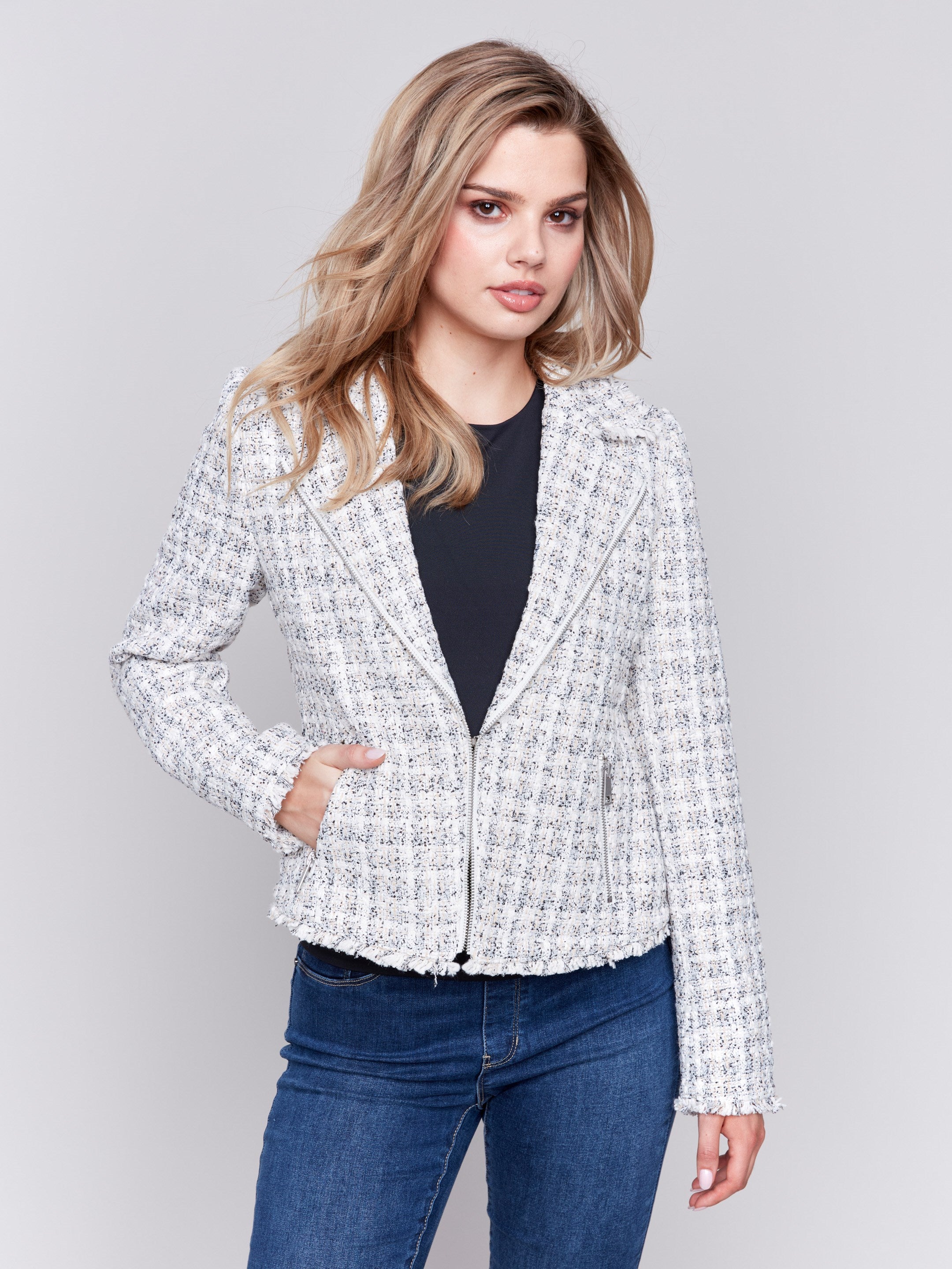 White tweed perfecto jacket with a lapel notch collar, side pockets, and hook-and-eye closure by Charlie B.