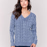 Denim blue cable knit sweater with a V-neckline, long sleeves, and geometric patterns by Charlie B.