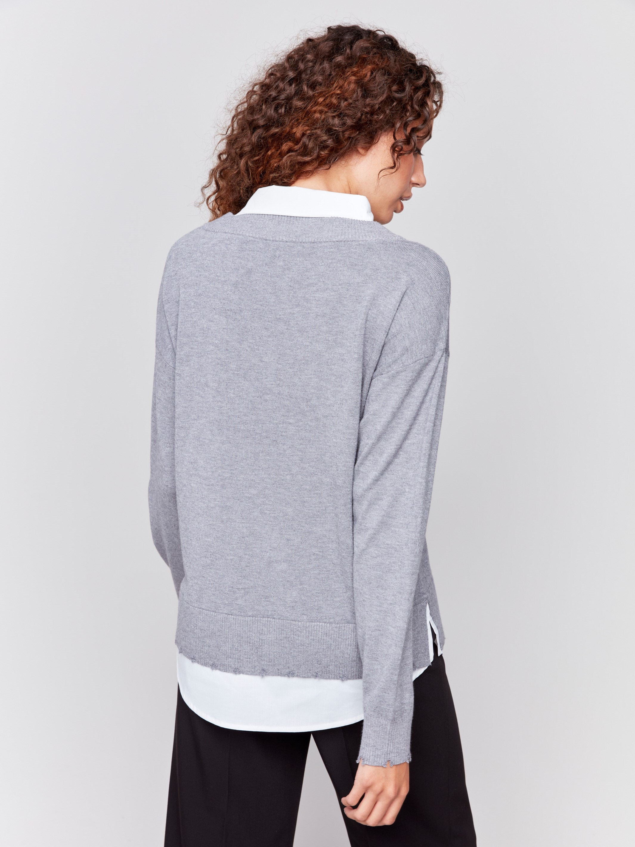 Grey V-neck fooler sweater with white shirt collar, featuring a shirttail hem and side slits by Charlie B.