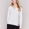 Cream-colored V-neck sweater with long sleeves featuring grommet details at the side placket by Charlie B.