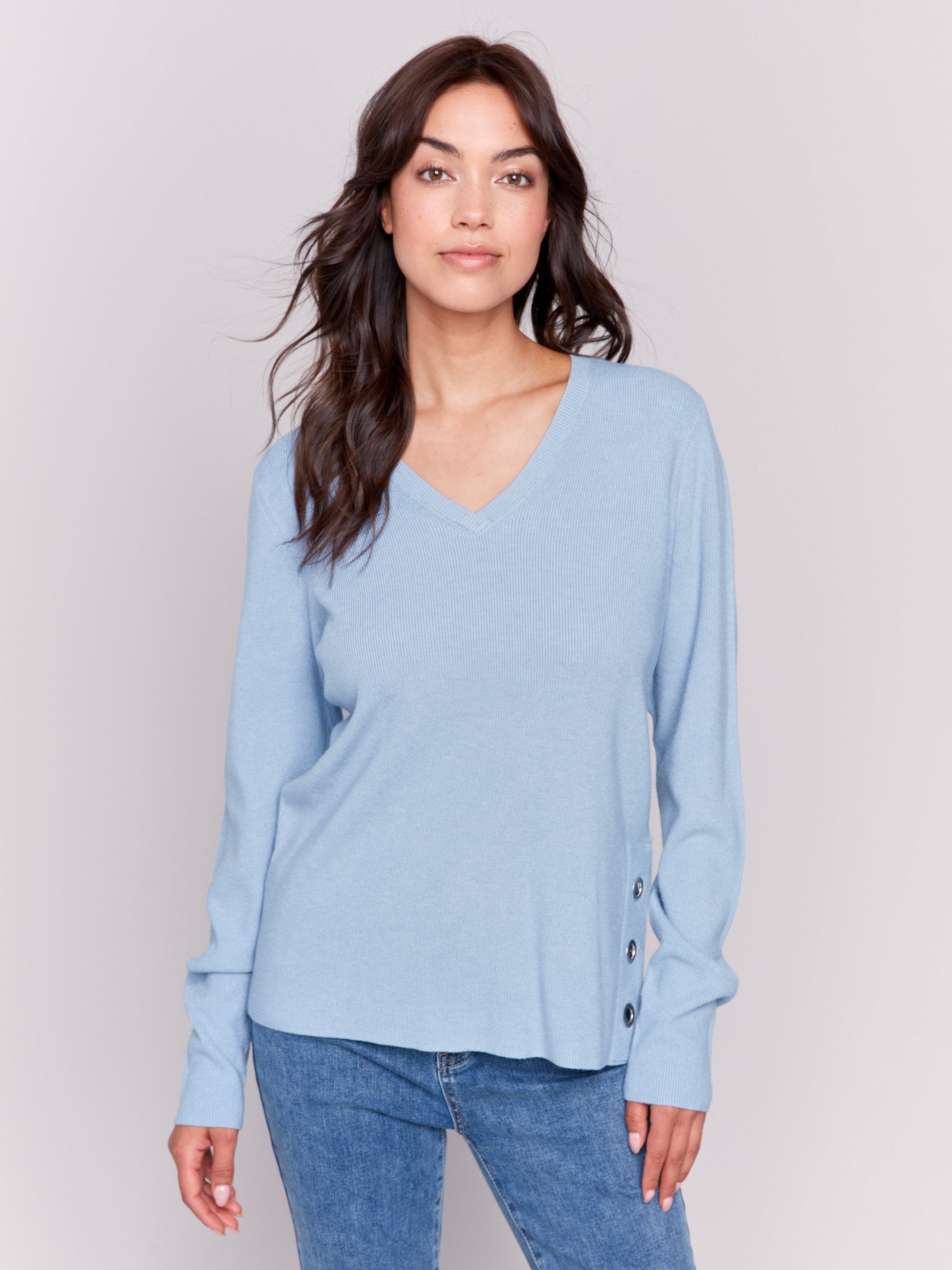 Frost-colored V-neck sweater with long sleeves featuring grommet details at the side placket by Charlie B.