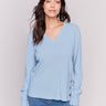 Frost-colored V-neck sweater with long sleeves featuring grommet details at the side placket by Charlie B.