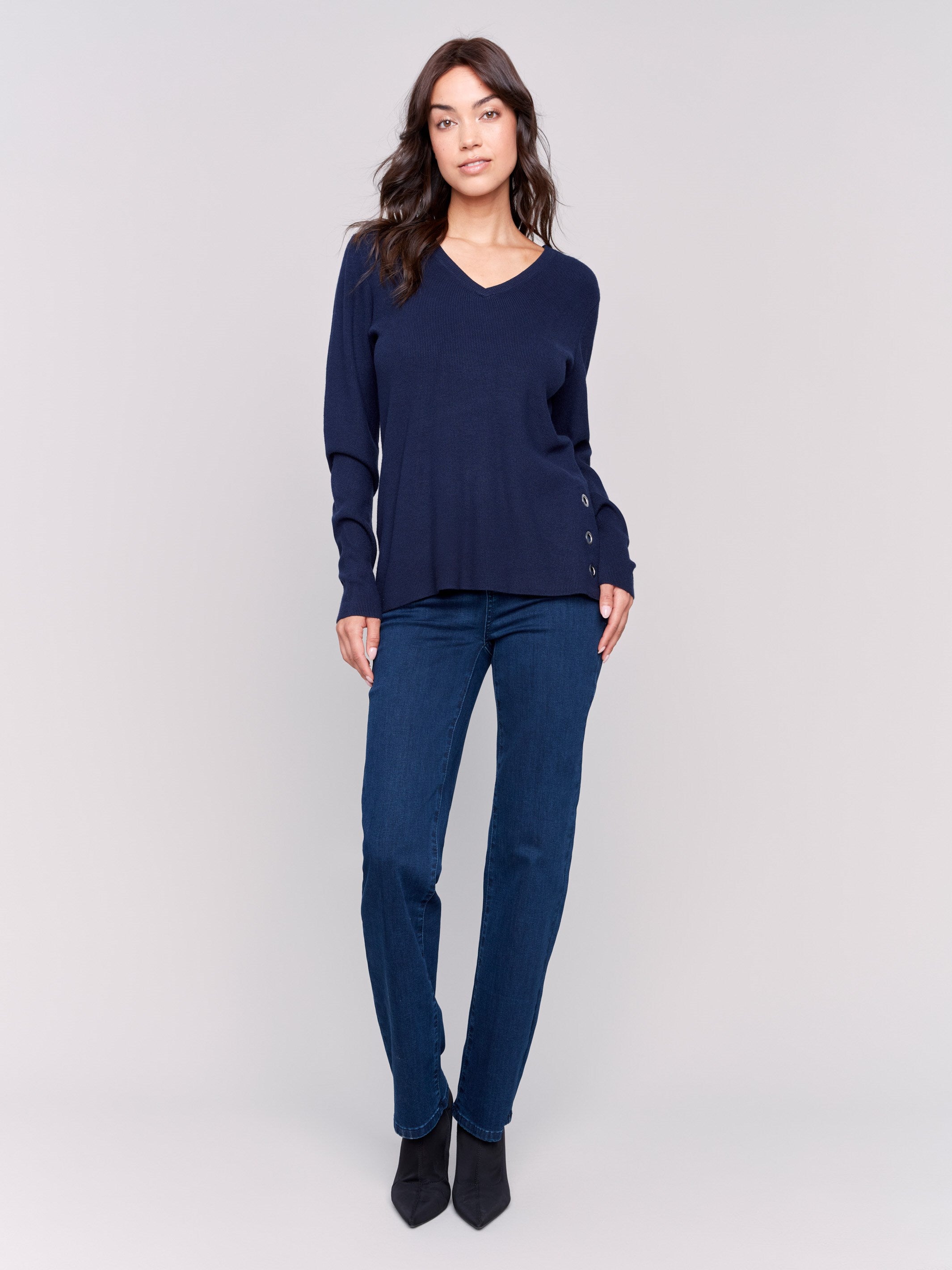 Navy-colored V-neck sweater with long sleeves featuring grommet details at the side placket by Charlie B.