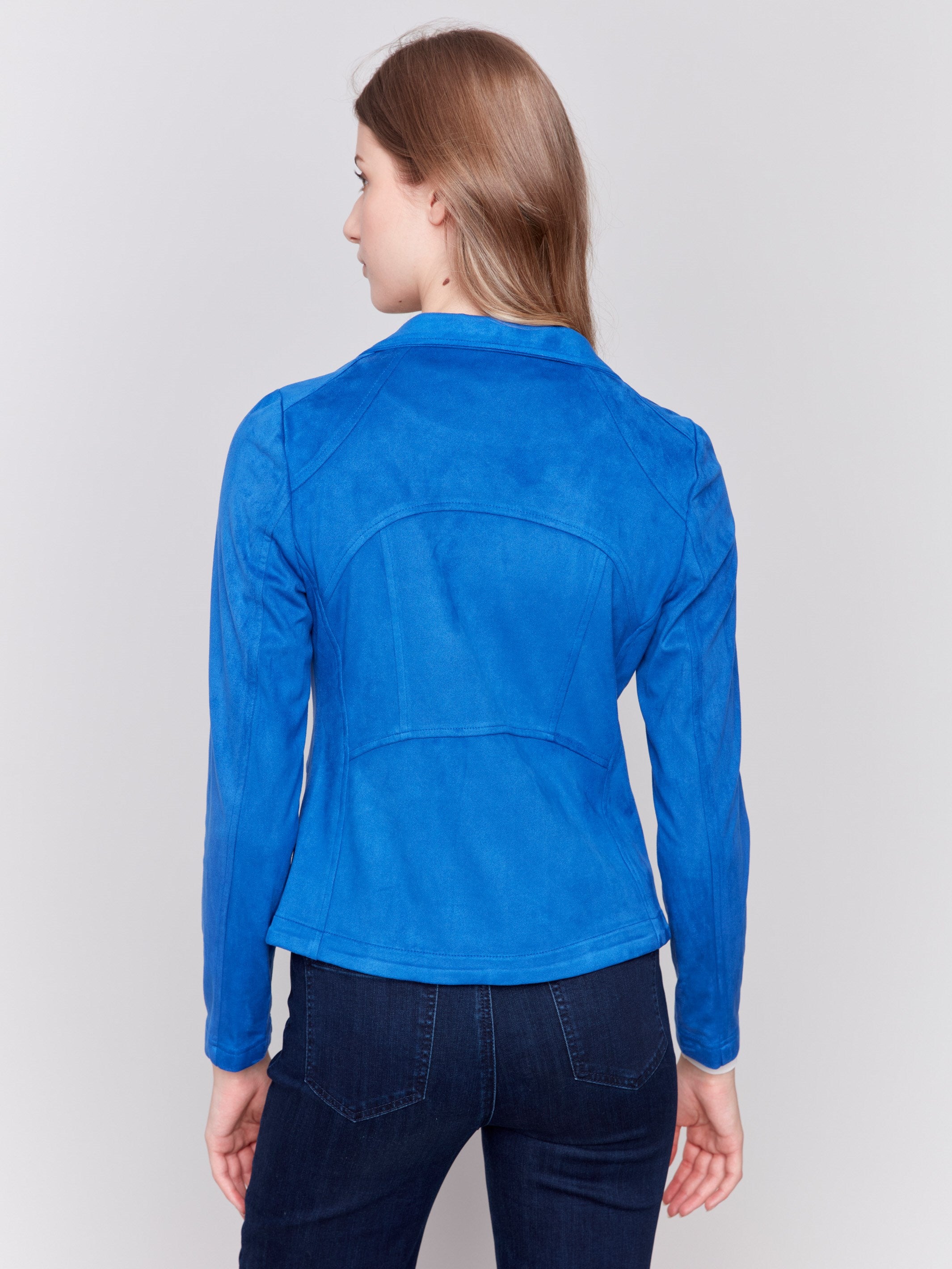 Sapphire blue faux suede jacket with silver zipper details, featuring a lapel collar and a fitted silhouette by Charlie B.